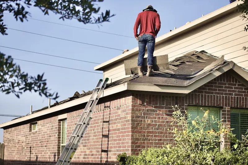 Professional roofer working on a residential roof in Harford Heritage